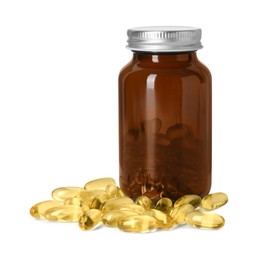 Photo of Bottle and pile of softgel capsules isolated on white