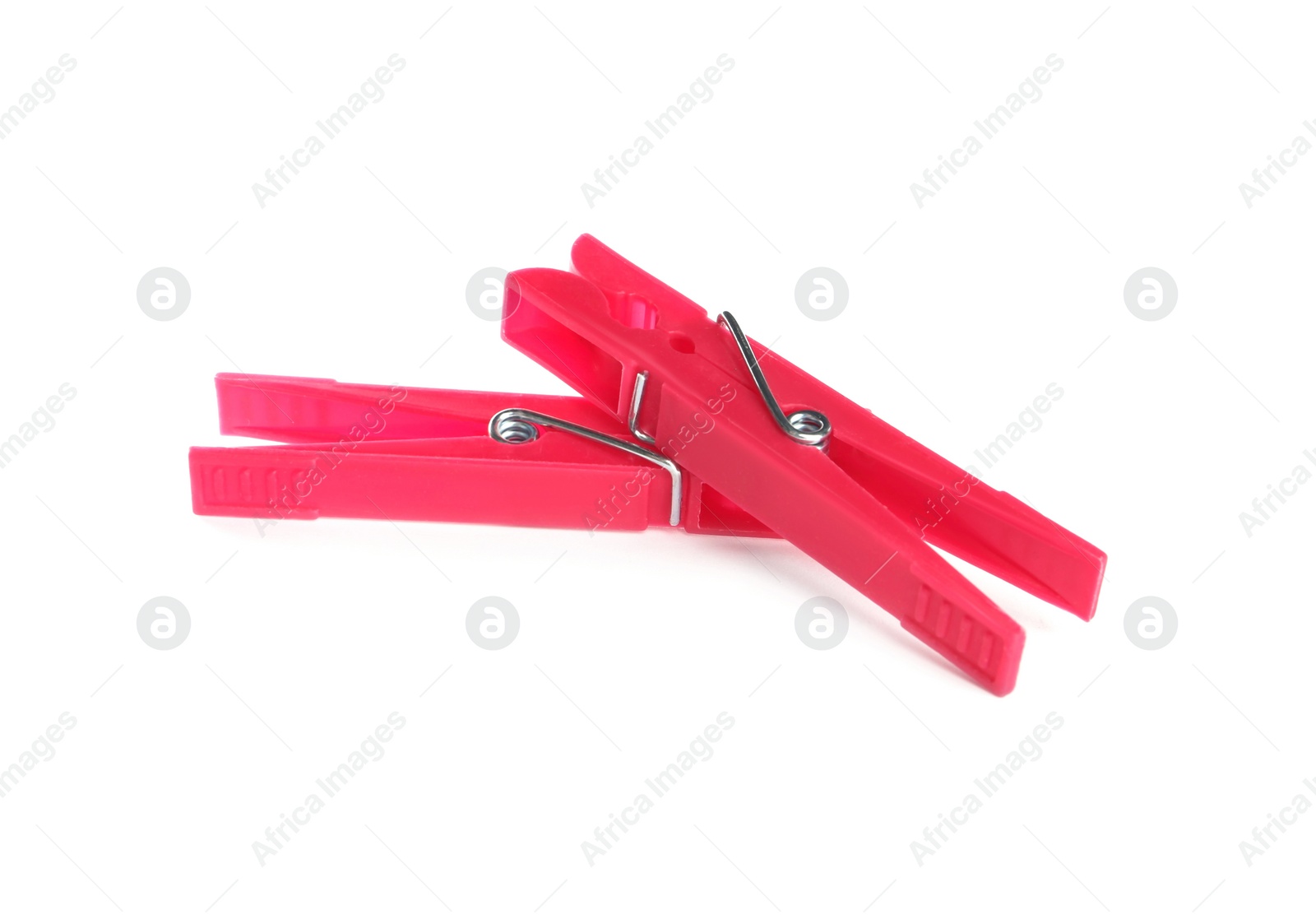 Photo of Bright pink plastic clothespins on white background