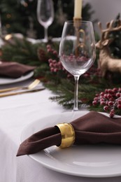 Beautiful festive place setting with Christmas decor on table