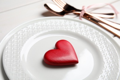 Photo of Beautiful place setting for romantic dinner on white table, closeup. Valentine's day celebration