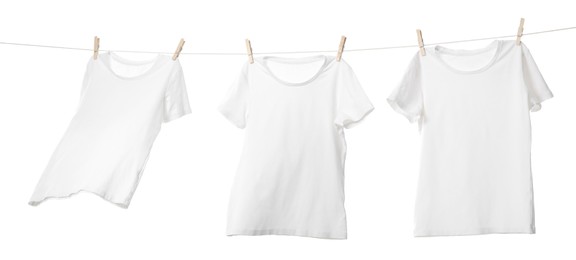 Many t-shirts drying on washing line isolated on white