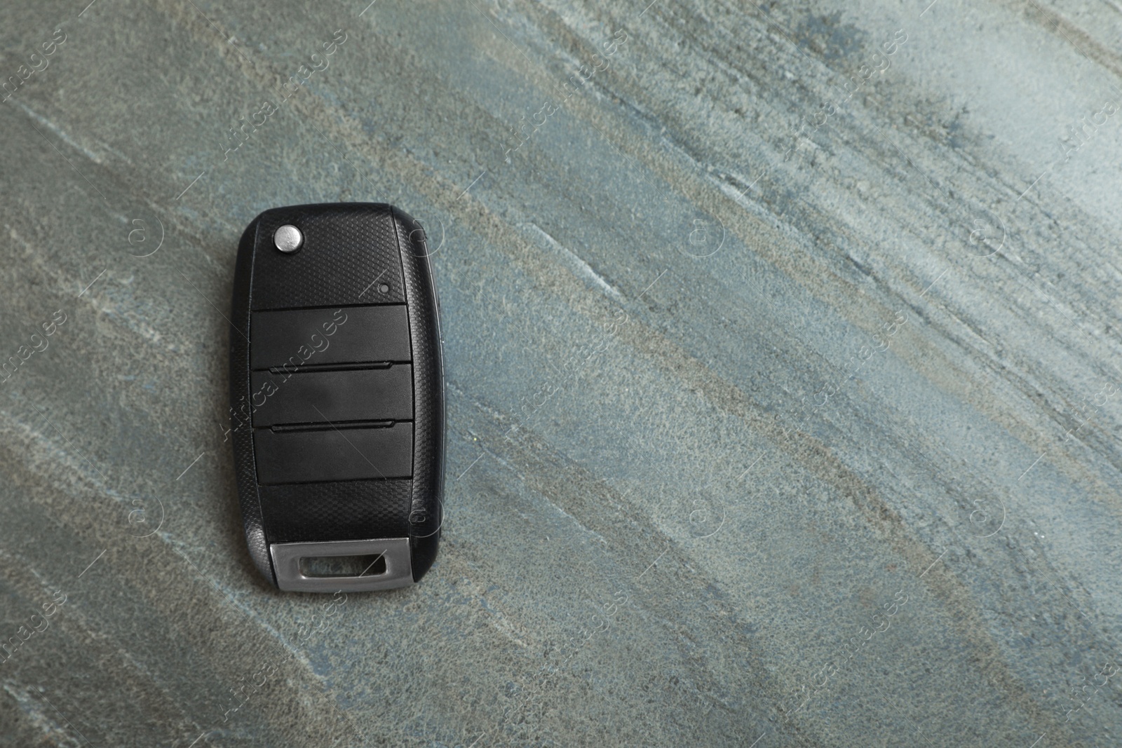 Photo of Car  flip key on grey background, top view with space for text