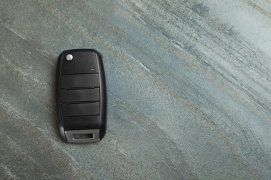 Car  flip key on grey background, top view with space for text