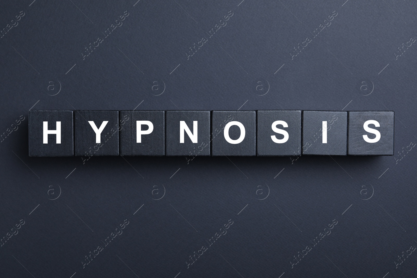 Photo of Wooden blocks with word HYPNOSIS on black background, flat lay