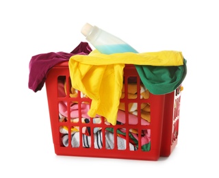 Laundry basket with dirty clothes and detergent on white background