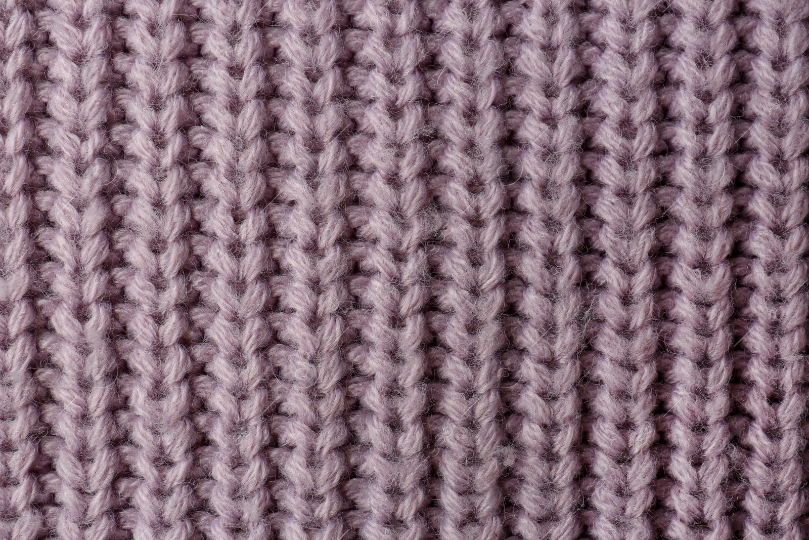 Photo of Beautiful violet knitted fabric as background, top view