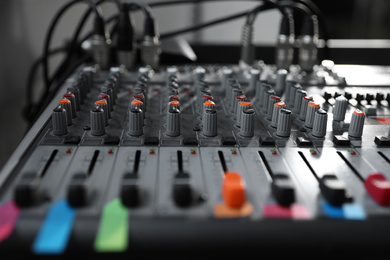 Photo of Modern audio mixing console, closeup. Music equipment