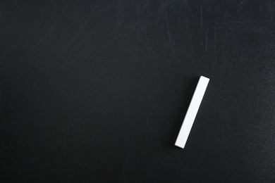 Photo of Piece of chalk on blackboard, top view