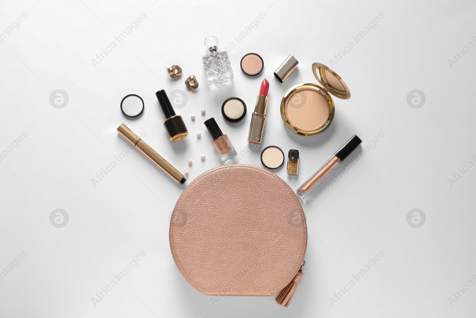 Photo of Cosmetic bag and different luxury makeup products on white background, top view