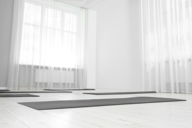 Spacious yoga studio with exercise mats, low angle view
