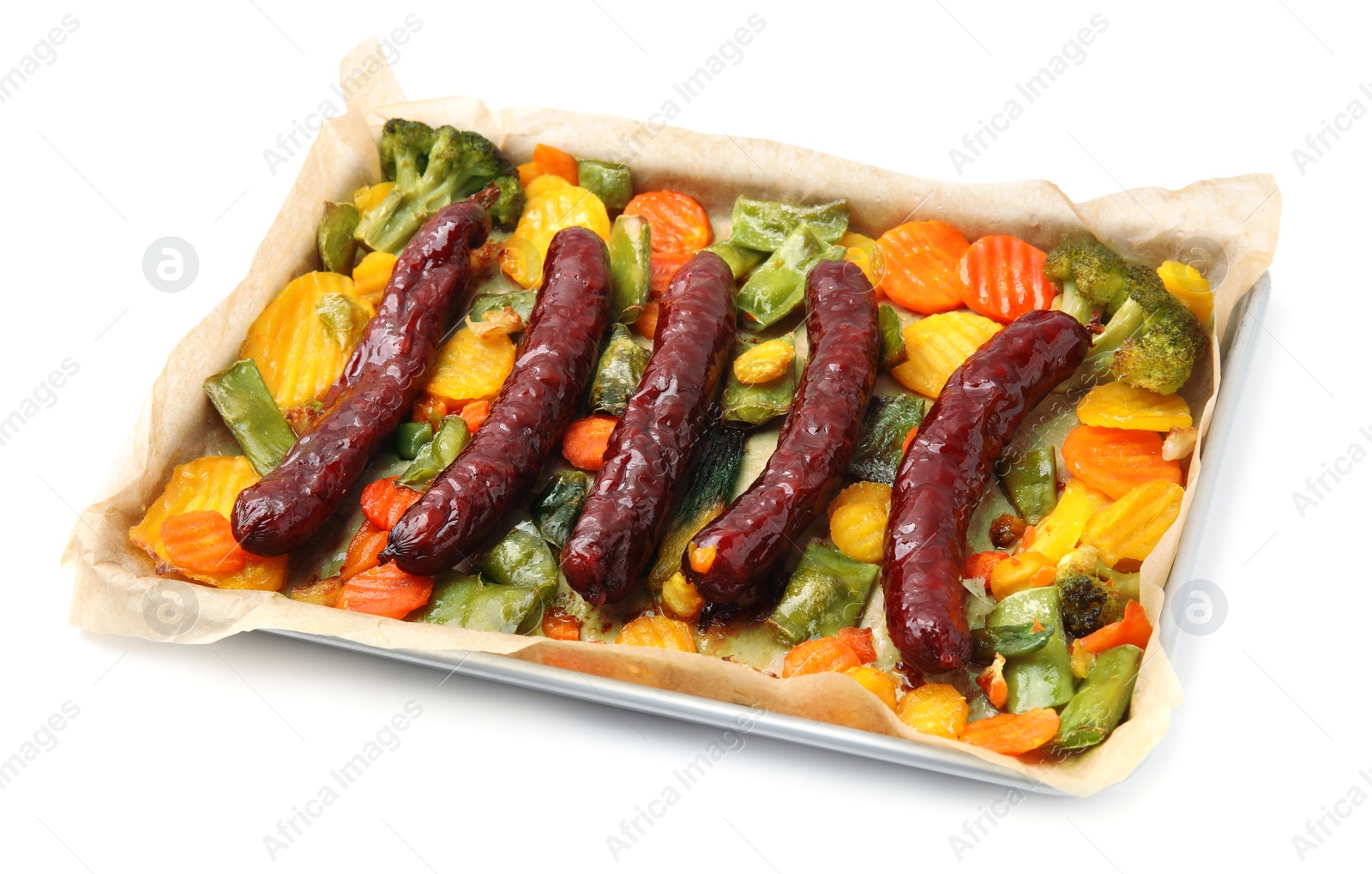 Photo of Baking tray with delicious smoked sausages and vegetables isolated on white