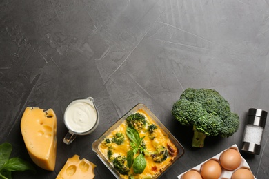 Photo of Flat lay composition with tasty broccoli casserole on grey table. Space for text