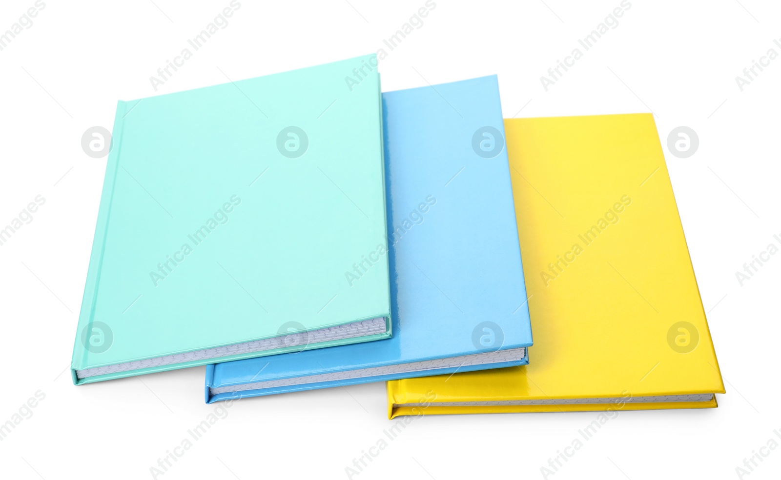 Photo of Different colorful hardcover planners on white background