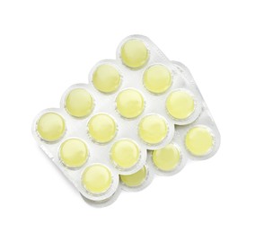 Blisters with yellow cough drops on white background, top view