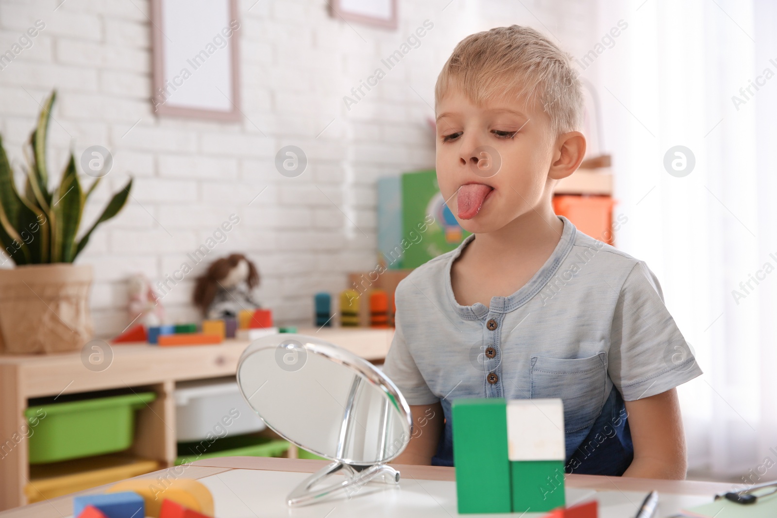 Photo of Cute little boy at speech therapist office