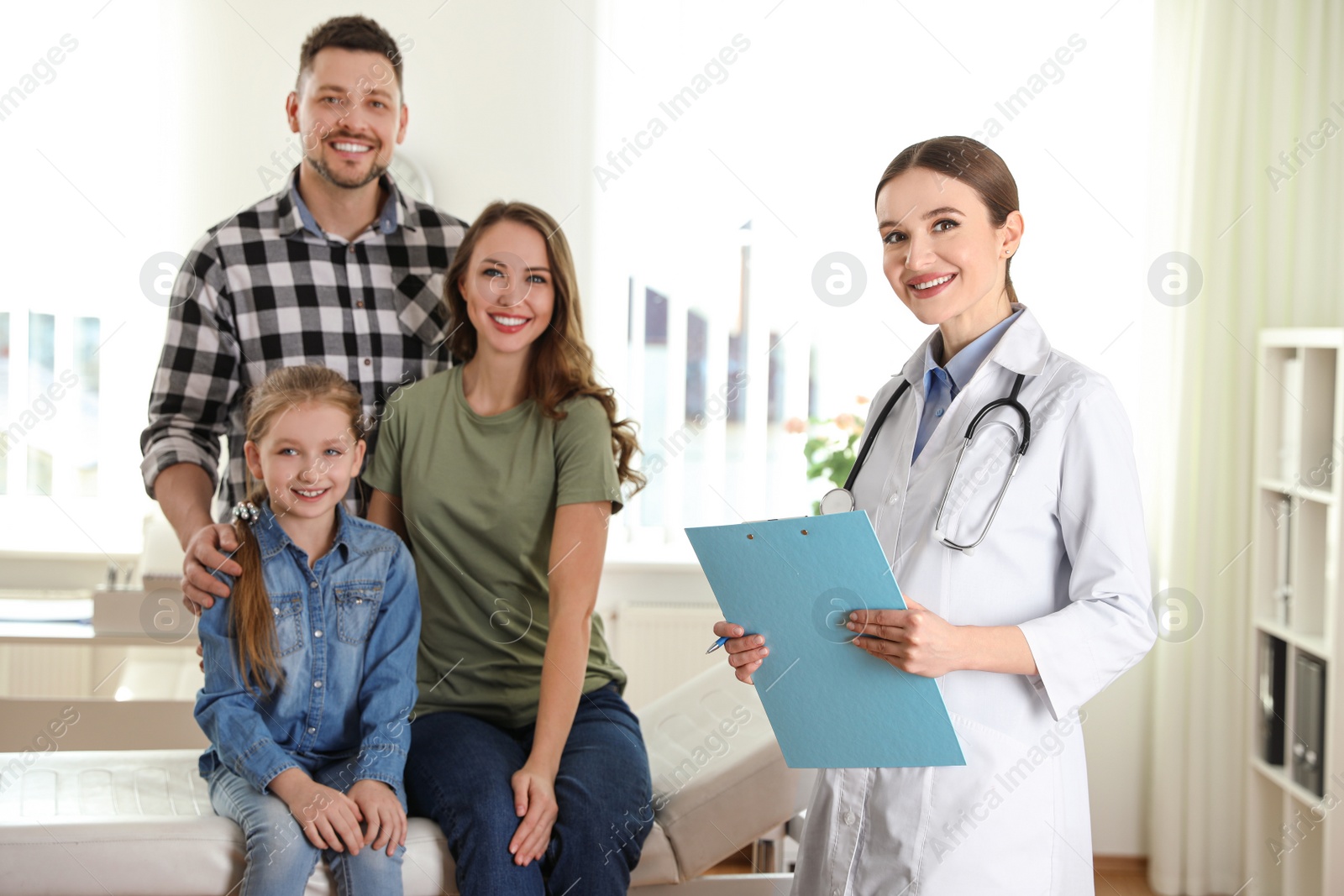 Photo of Parents and daughter visiting pediatrician. Doctor working with patient in hospital