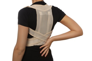 Photo of Closeup view of woman with orthopedic corset on white background