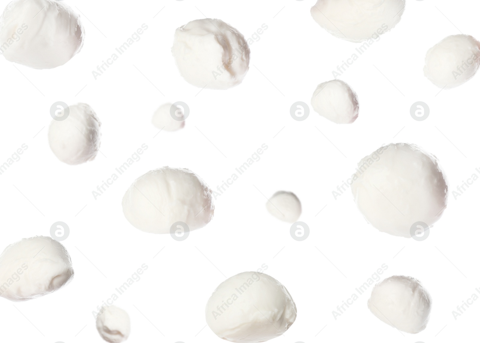 Image of Mozzarella cheese balls falling on white background