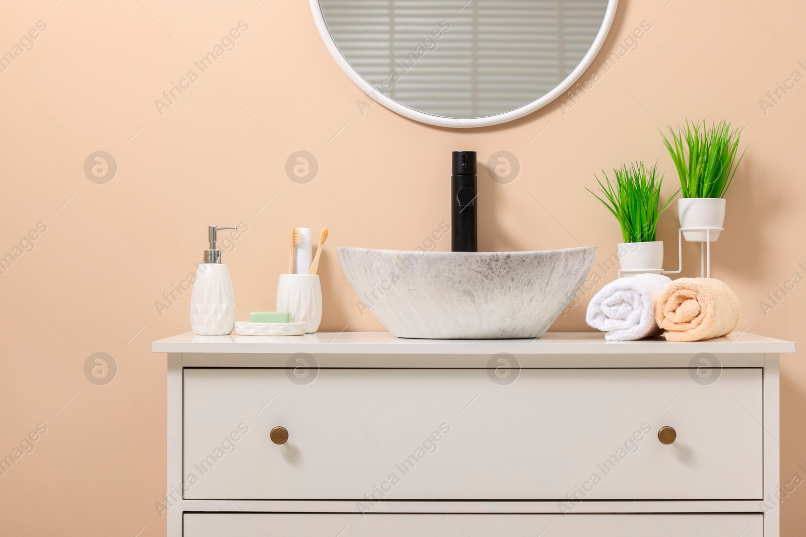 Photo of Different bath accessories and personal care products near sink on bathroom vanity