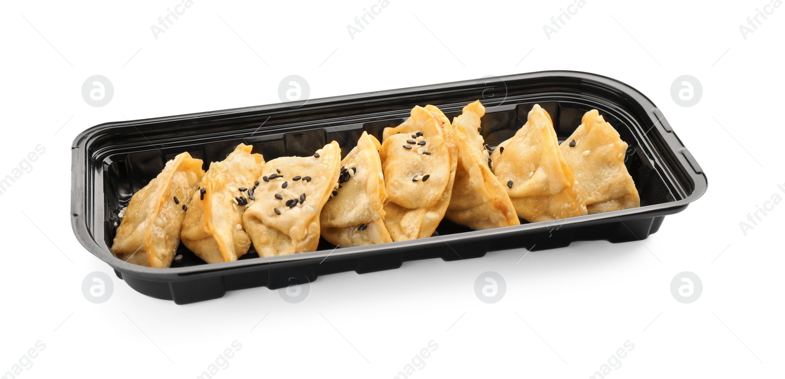Photo of Delicious gyoza (asian dumplings) with sesame isolated on white