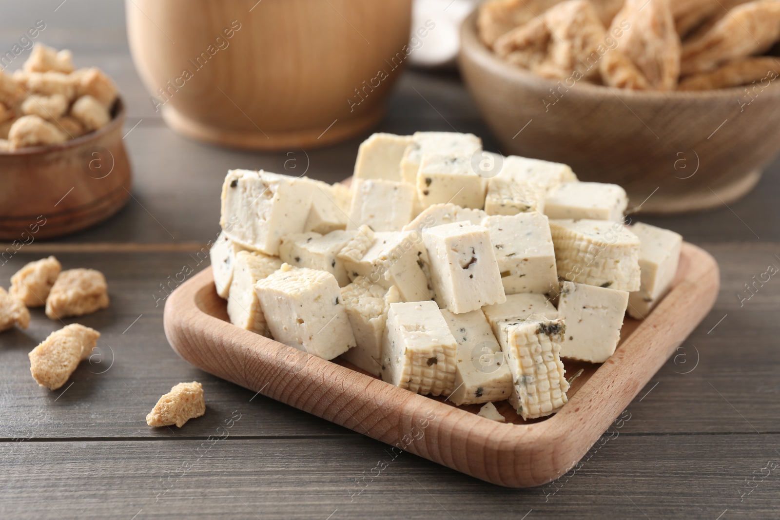 Photo of Natural tofu on wooden table, closeup. Soy product