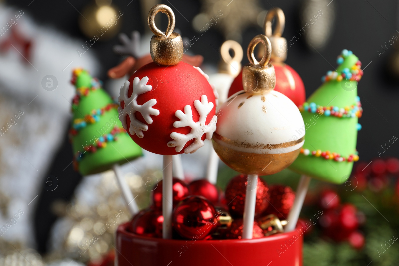 Photo of Delicious Christmas themed cake pops on blurred  background, closeup
