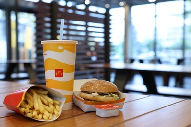 Photo of Lviv, Ukraine - October 9, 2023: McDonald's menu on wooden table in restaurant, space for text