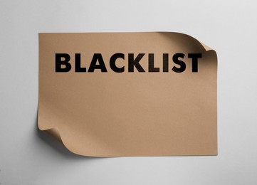Image of Paper with word Blacklist on light background, top view