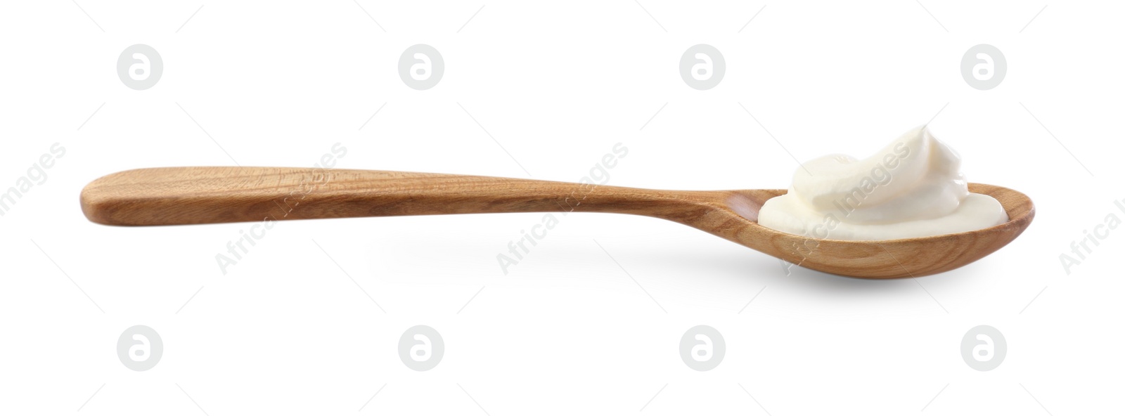 Photo of Sour cream in wooden spoon isolated on white