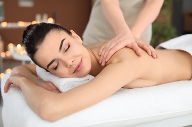 Young woman receiving massage in spa salon