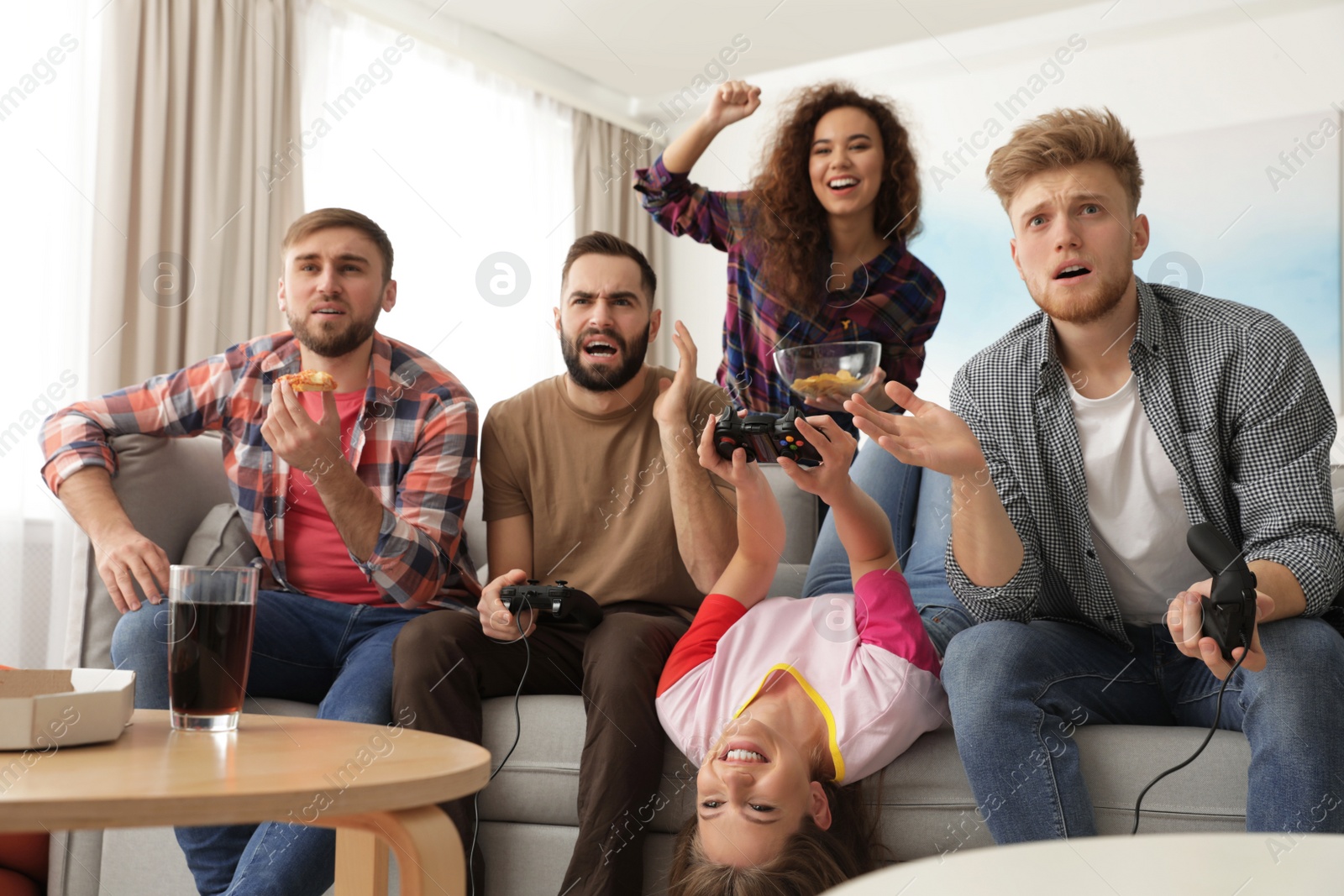 Photo of Emotional friends playing video games at home