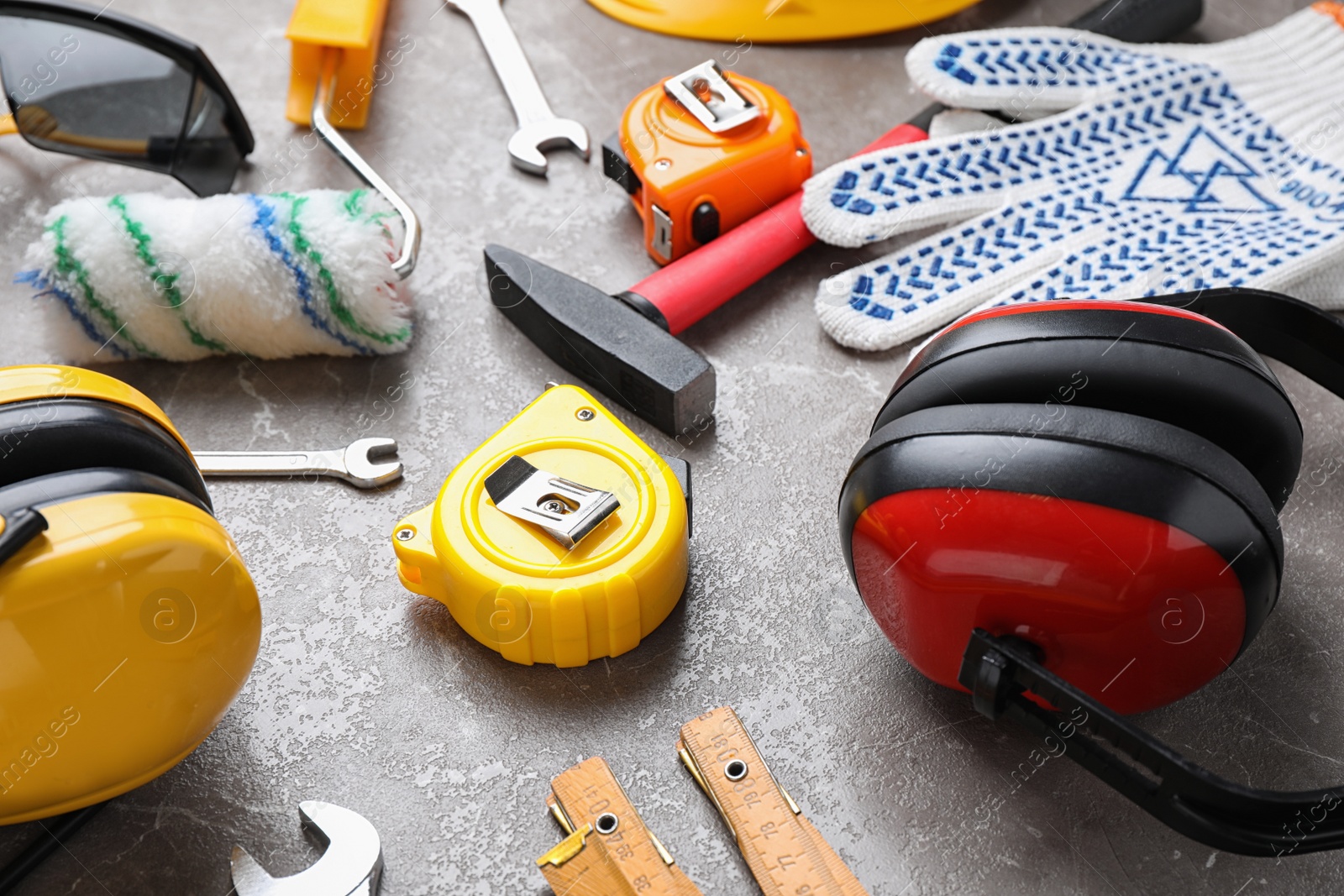 Photo of Many different construction tools on grey marble table