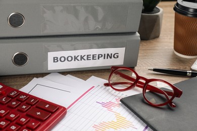 Photo of Bookkeeper's workplace with folders and documents on table