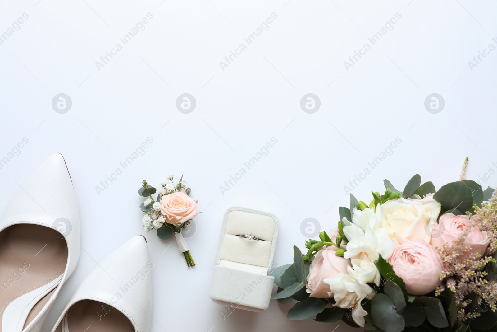 Photo of Composition with wedding high heel shoes on white background, top view