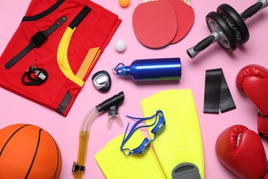 Photo of Flat lay composition with sports equipment on pink background
