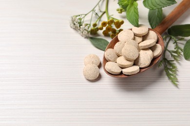 Photo of Pills, herbs and flowers on white wooden table, closeup with space for text. Dietary supplements