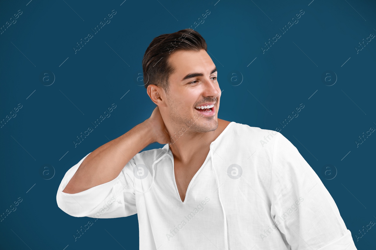 Photo of Portrait of handsome young man on blue background