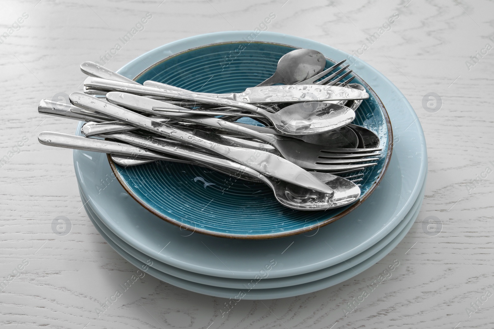 Photo of Different clean kitchenware on white wooden table