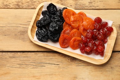 Photo of Delicious dried fruits on wooden table, top view