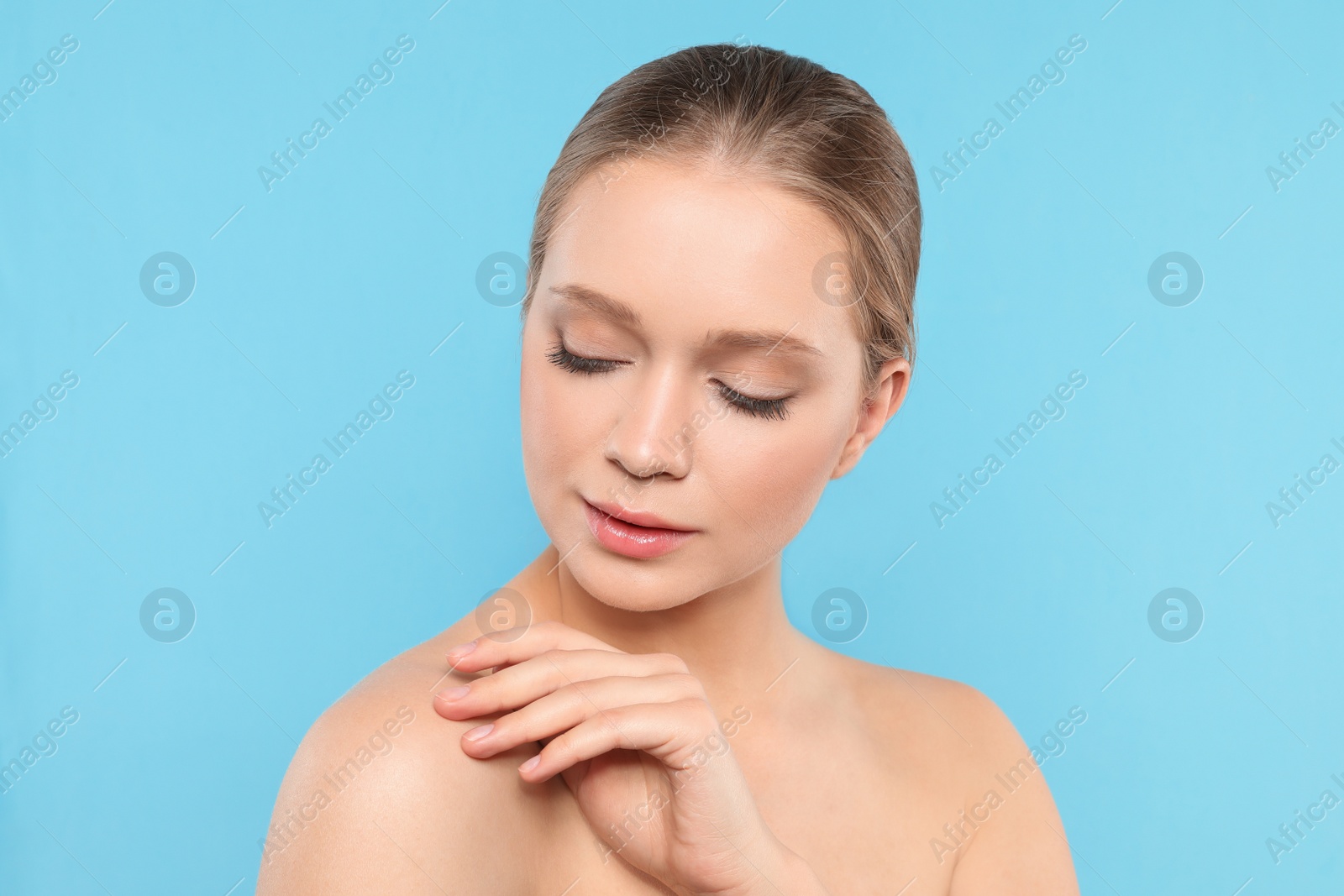 Photo of Portrait of young woman with beautiful face on blue background