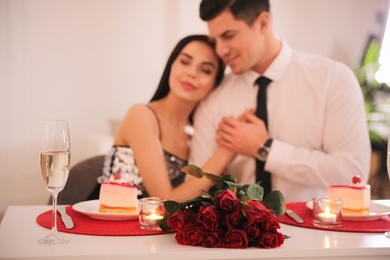 Happy couple having romantic dinner on Valentine's day in restaurant