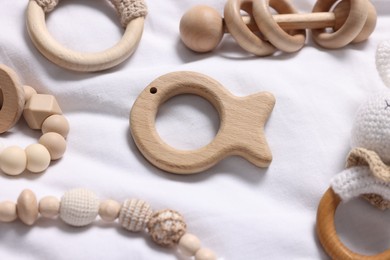 Photo of Many different baby accessories on white fabric