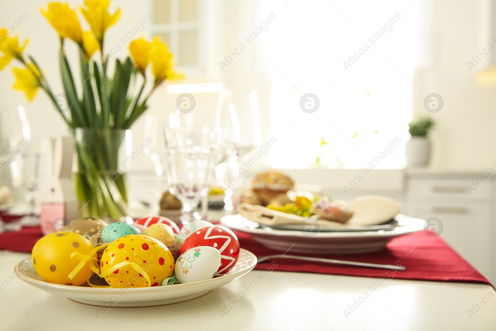 Photo of Festive Easter table setting with decorated eggs, closeup