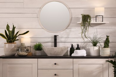 Photo of Stylish bathroom interior with vessel sink and beautiful plants