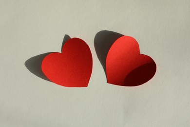 Photo of Paper hearts on light grey background, flat lay