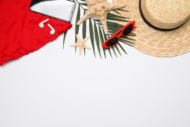 Photo of Flat lay composition with beach objects on white background. Space for text