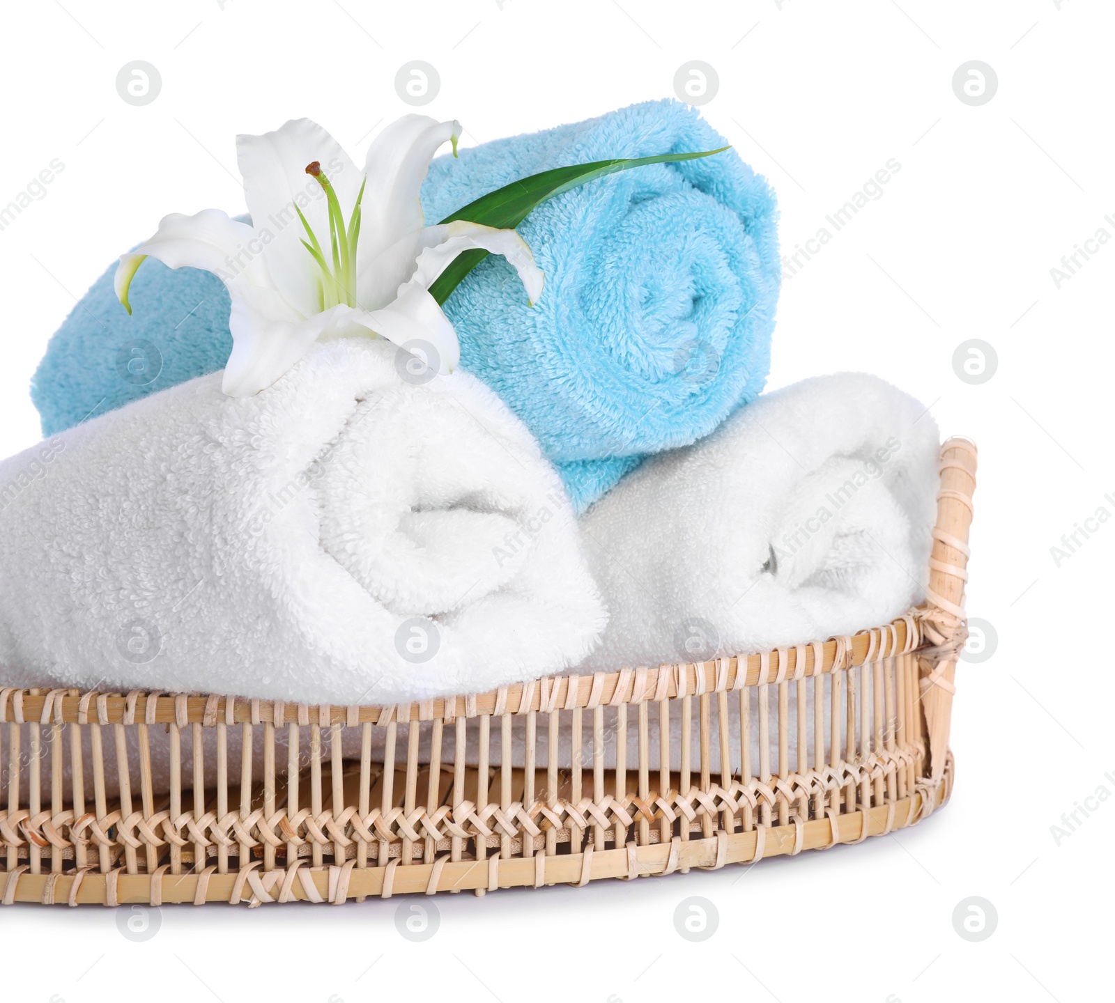 Photo of Wicker tray with towels and flower isolated on white. Spa treatment