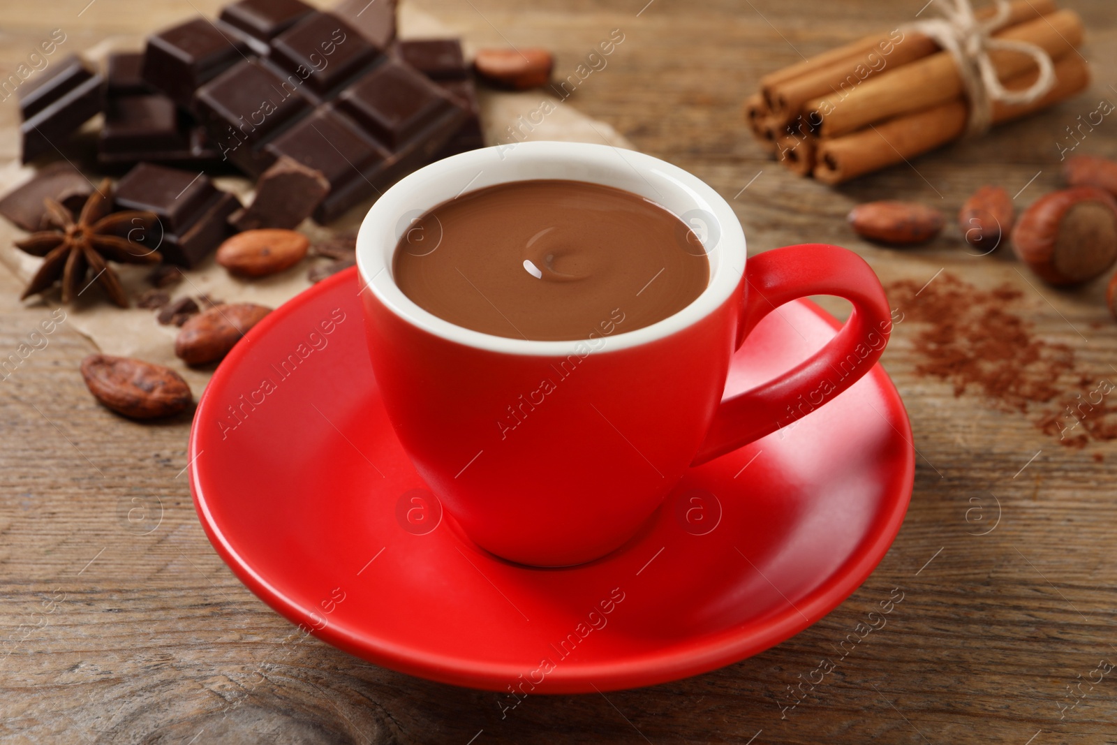 Photo of Yummy hot chocolate in cup on wooden table
