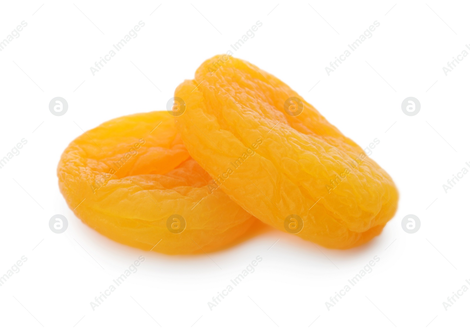 Photo of Two tasty apricots on white background. Dried fruits