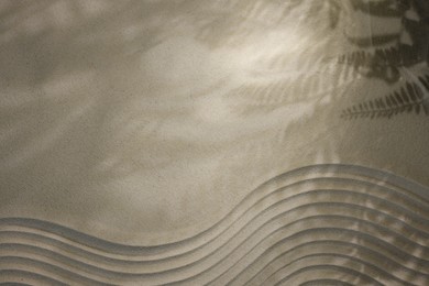 Photo of Beautiful lines and shadows of leaves on sand, top view with space for text. Zen garden